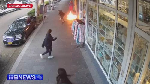 A family have been forced to jump over flames to escape a burning shop on the NSW Central Coast.
