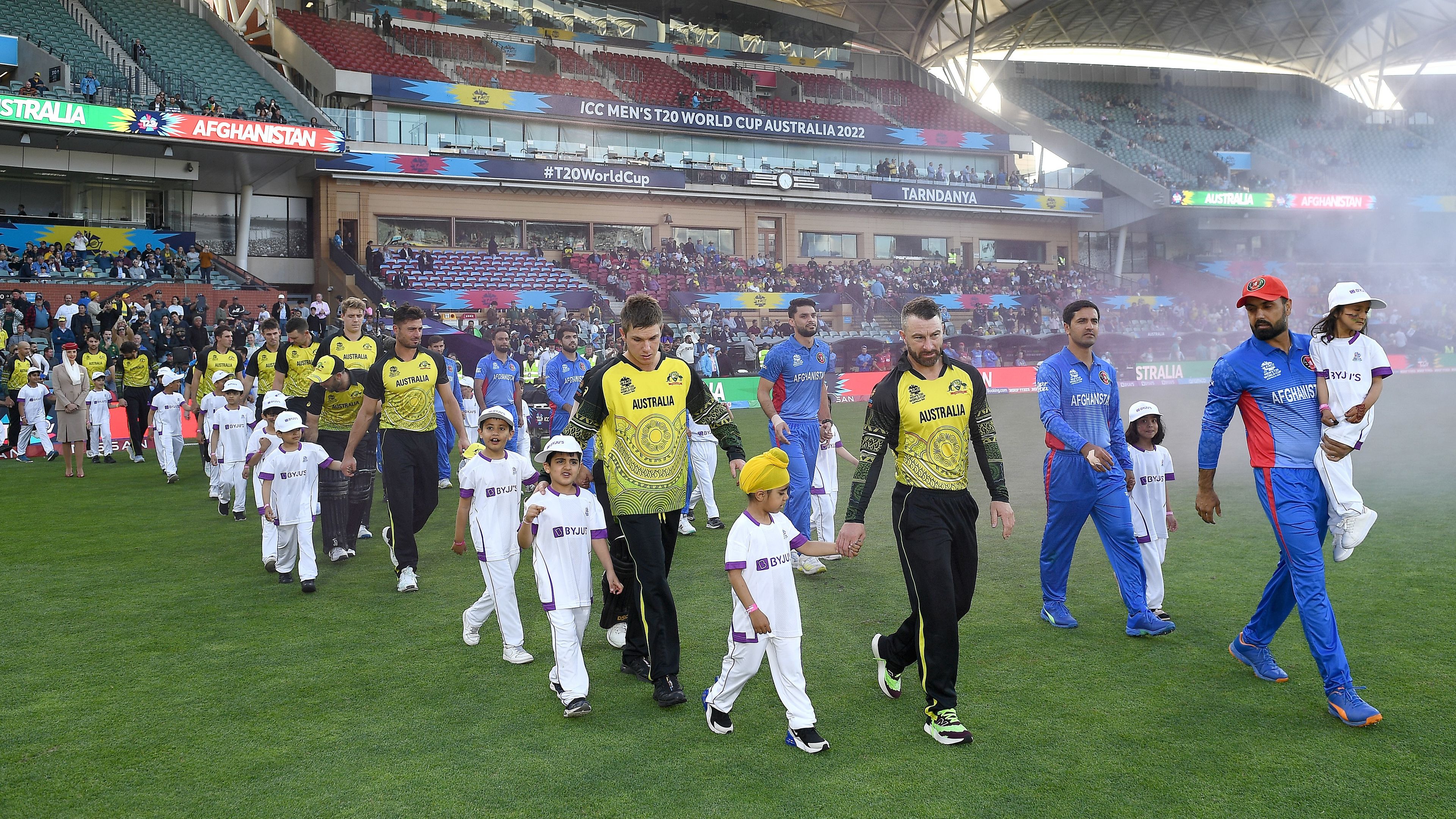Australia and Afghanistan walk out onto Adelaide Ovan during the 2022 ICC Men&#x27;s T20 World Cup