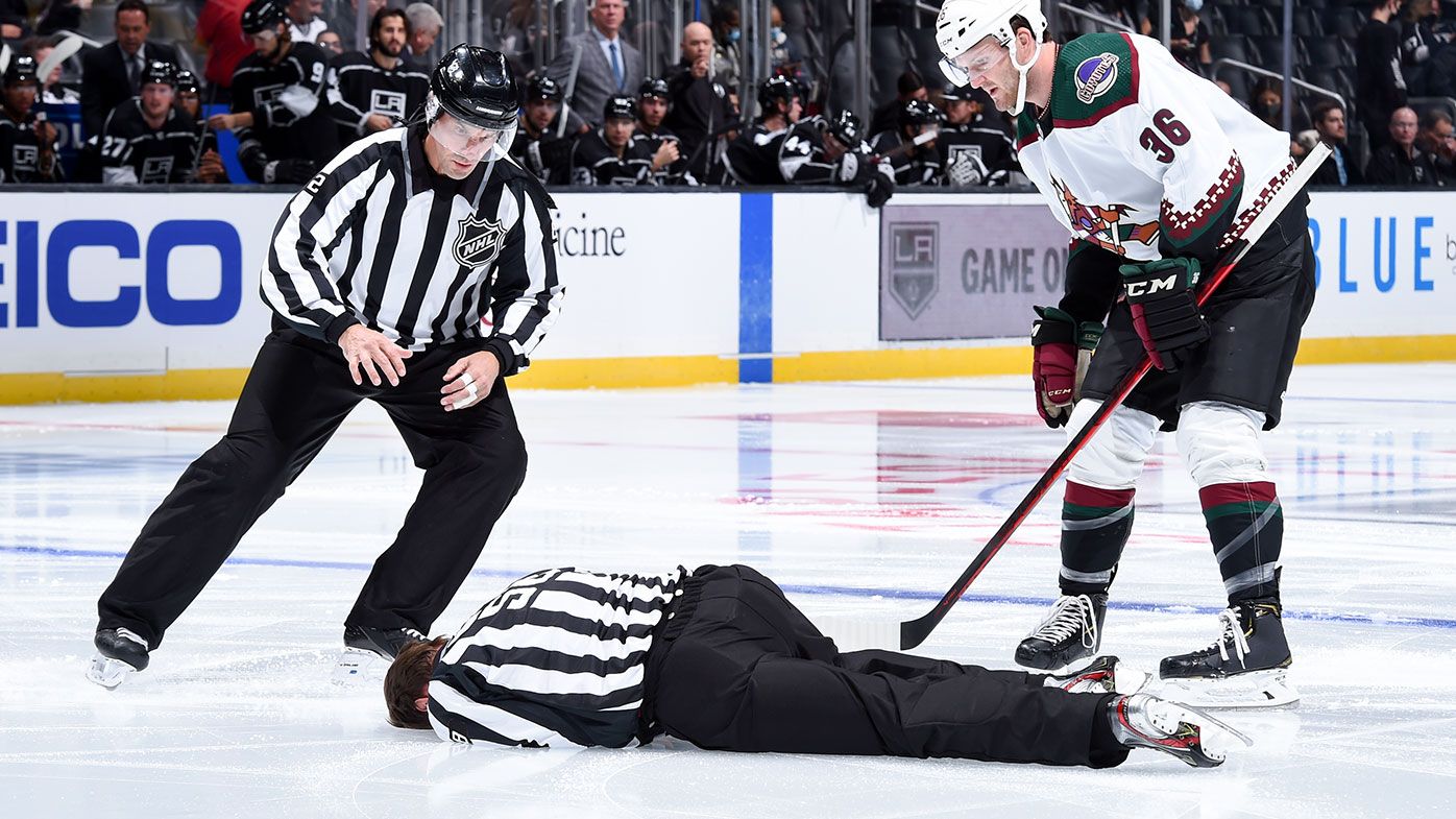 LOS ANGELES, CA - OCTOBER 5: NHL Linesman Ryan Gibbons is tended to after an injury prior to the first period between Los Angeles Kings and Arizona Coyotes at STAPLES Center on October 5, 2021 in Los Angeles, California. (Photo by Juan Ocampo/NHLI via Getty Images)