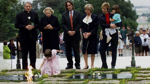Saoirse Kennedy lays a white rose at President John F. Kennedy's gravesite in 2000. 