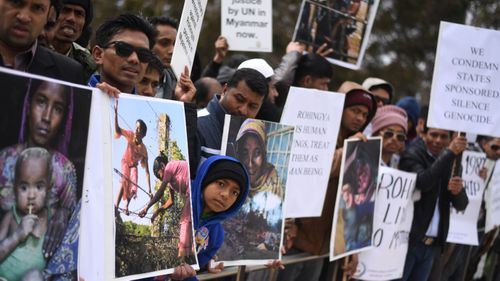 A young member of the Rohingya Muslim community attends a protest outside Parliament House in Canberra. (AAP)