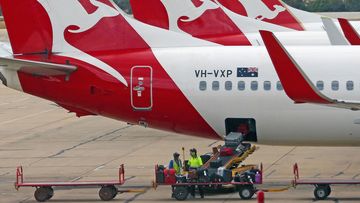 Baggage is loaded onto a Qantas jet at Melbourne Tullamarine Airport. 