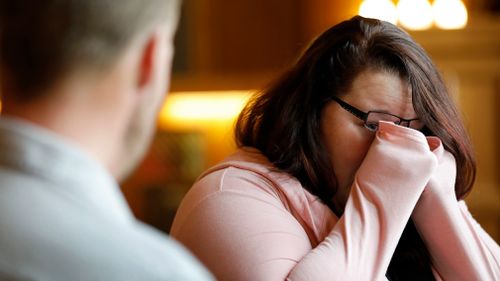 Lilly Ross reacts as she talks with face transplant recipient Andy Sandness. (AAP)