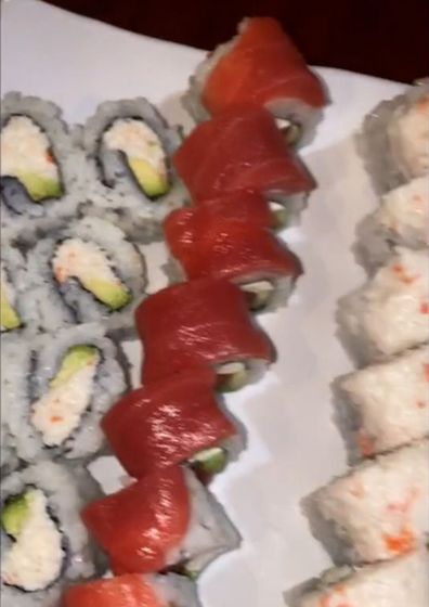 Woman overeats sushi at buffet