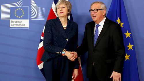 British Prime Minister Theresa May is icy as she shakes the hand of European commission President Jean-Claude Juncker.