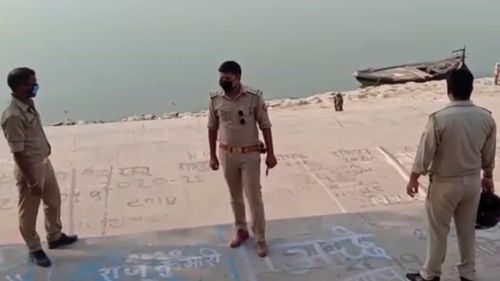 Police officials stand guard at the banks of the river where several bodies were found lying in Ghazipur district in Uttar Pradesh.