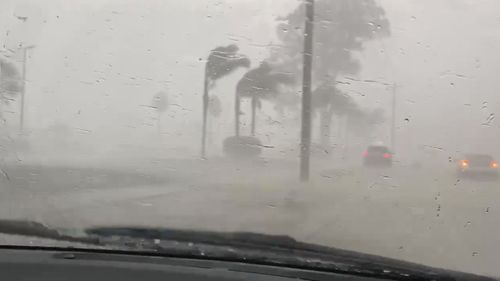 Strong winds and heavy rain lash drivers in St Marys, in western Sydney.