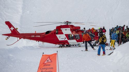 Rescue forces and helicopters search for missed persons after an avalanche swept down a ski piste in the central town of Andermatt.