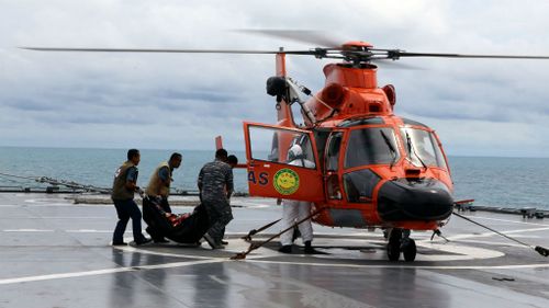 Indonesian divers find AirAsia bodies still strapped into seats