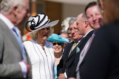 Queen Camilla speaks to guests during a Royal Garden Party at Buckingham Palace on May 8, 2024 in London