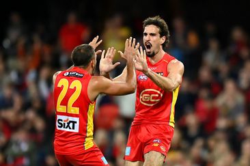 Ben King of the Suns celebrates kicking a goal.