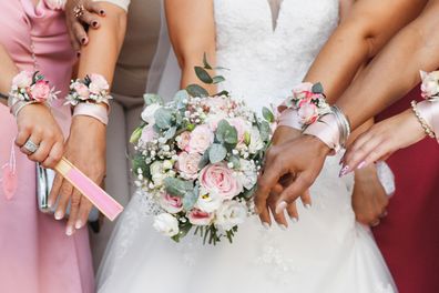 bride standing with bridesmaid wearing a pink dress