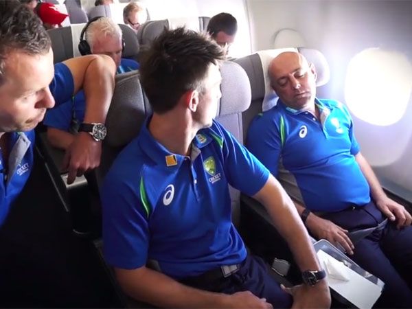 Peter Siddle (L) and Mitch Marsh chat to a sleeping Darren Lehmann (R). (Supplied)