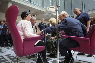 King Charles III and Queen Camilla meet with Lesley Woodbridge, patient receiving the second round of chemotherapy for sarcoma and her husband Roger Woodbridge during a visit to the University College Hospital Macmillan Cancer Centre in London, Tuesday April 30, 2024. 