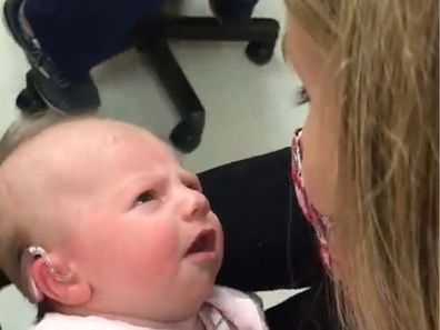 Deaf baby in her mother's arms