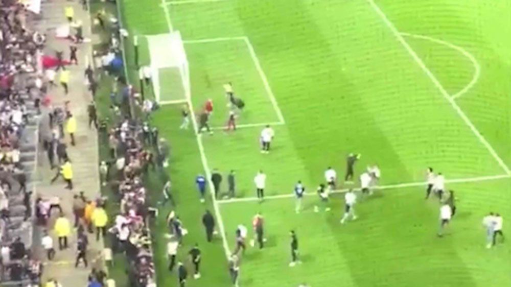 Fans invade pitch due to crowd disturbances in Europa League clash between Lyon and Besiktas