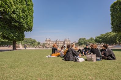 Paris / France - May 18, 2018: Students hang out having lunch on the lawn at the Luxembourg Palace and Gardens, a popular and historic park in the Montparnasse neighborhood.