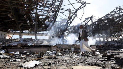 A Houthi militiaman inspects the site of an alleged Saudi-led airstrike. (EPA)