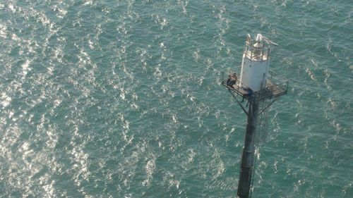 Two men were found clinging to a marker buoy north-east of Darwin. (supplied)