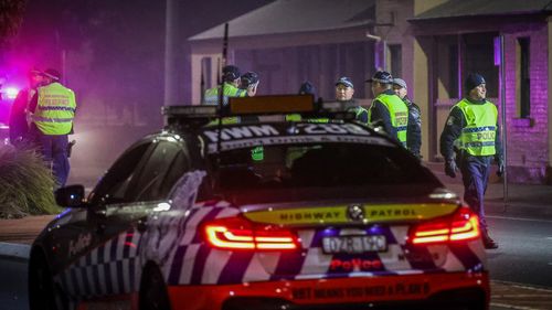 Police stop and question drivers at a checkpoint in Albury, Australia. The NSW-Victoria border closed at midnight, Wednesday 8 July. 