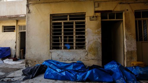 Body bags pile up in a garage after they were recovered from a house destroyed by a reported air strike in the al-Jadida neighbourhood of Mosul, March, 2017.