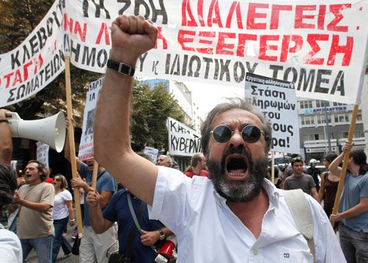 A demonstrator shouts anti government slogans in Thessaloniki, Greece. (AAP)
