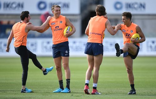 Patrick Cripps (second from left) and Ed Curnow (right) of the Blues are seen during Carlton training at Ikon Park in Melbourne yesterday. (AAP)