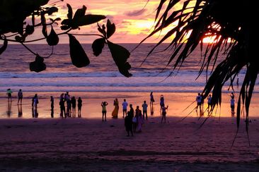 Bali, Indonesia - January 21, 2022 : Tourists enjoying sunset at Petitenget Beach, Bali, Indonesia
