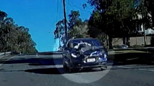 Video footage has captured the moment a man was left clinging to the bonnet of an allegedly stolen car, driven by a Queensland teenager.