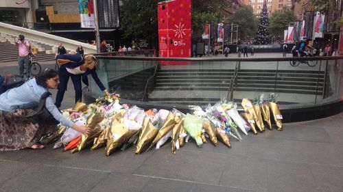 Every day a line would build down Martin Place. City workers, mothers with prams and toddlers, families, teenagers and grandparents all waiting patiently to place their flowers and their messages to the Johnson and Dawson families. 