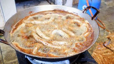 Frying sausage, Bali street food tour