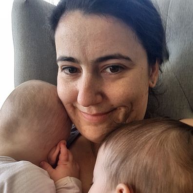Maddison Granger cuddles her twin daughters.