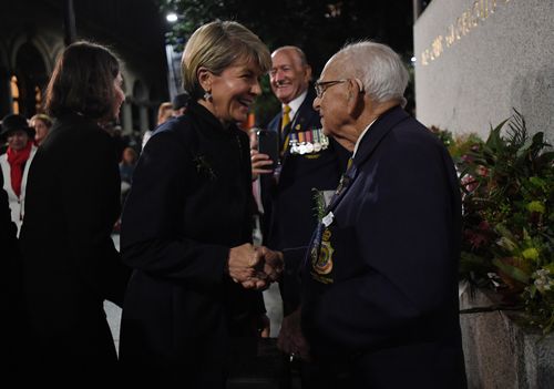 Foreign Minister Julie Bishop laughs as she shakes hands with Wally Smith. (AAP)