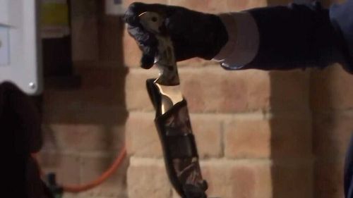 A knife and camouflage material were among the items seized by detectives. (9NEWS)