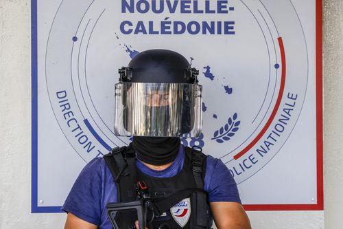 A policeman waits for the arrival of French President Emmanuel Macron at the central police station in Noumea, New Caledonia, Thursday, May 23, 2024.