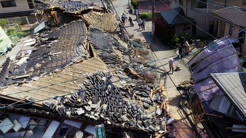 This aerial view shows damaged houses in Mashiki town, Kumamoto prefecture after the 6.2 quake. (AAP)