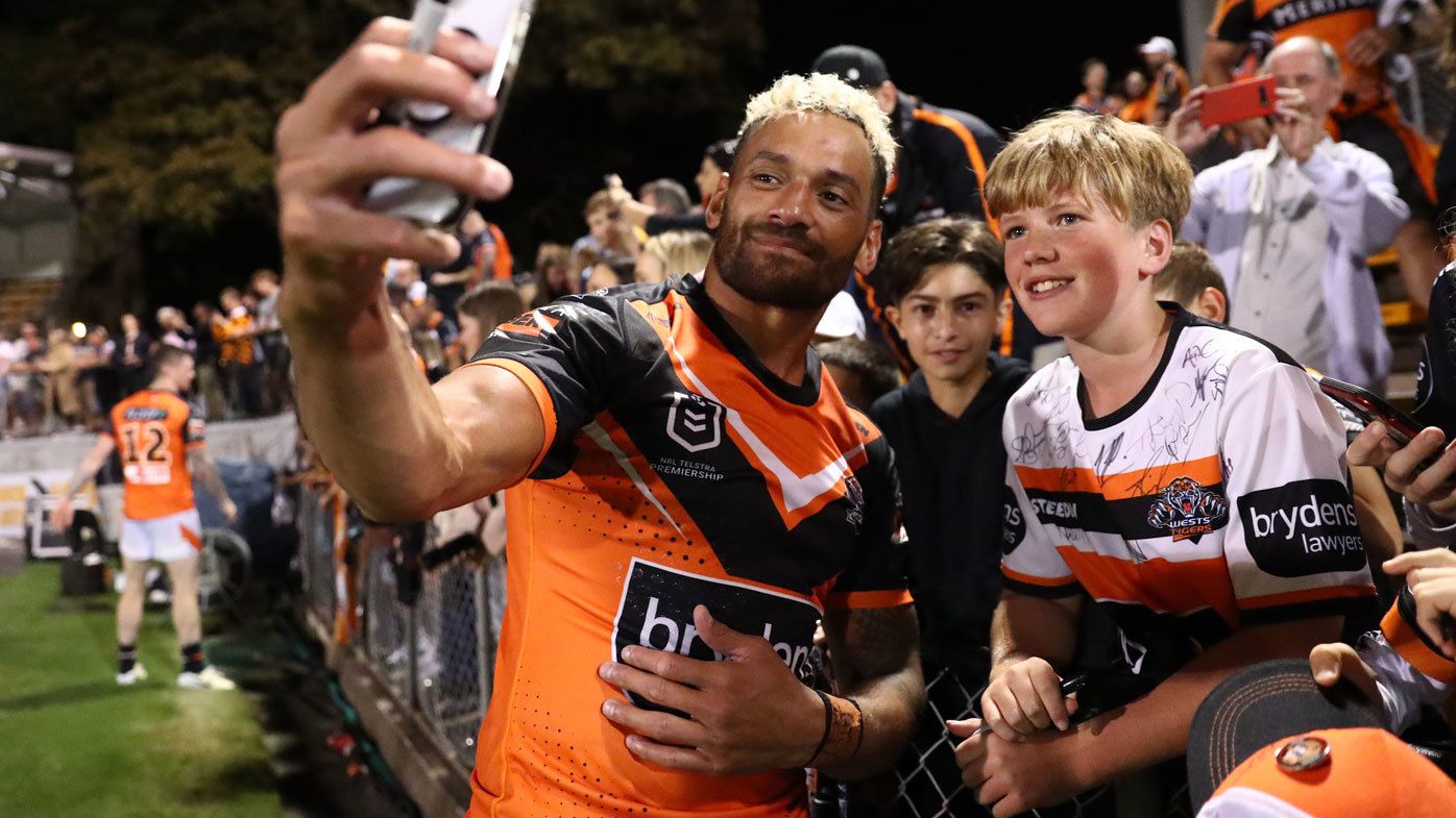 Wests Tigers captain Api Koroisau takes a selfie with a young fan at Leichhardt Oval.