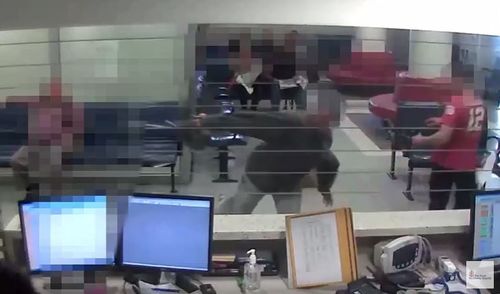 The video shows one man throw a chair at staff siting behind the counter at the emergency department. (YouTube)