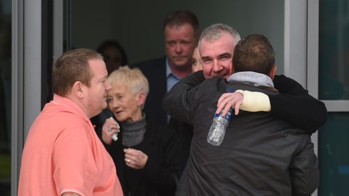 Relatives hug outside the Hillsborough inquests in Warrington.(AAP) 