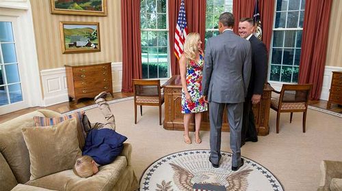 The President? Who cares? Restless boy faceplants on White House couch while parents talk to Barack Obama