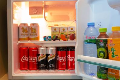 CHIANGMAI, THAILAND - December 28, 2020: Cold drink cans and bottles in the mini hotel refrigerator at night