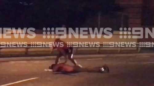 The man was pushed on the road and then punched a number of times. (9NEWS)