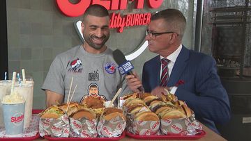 Professional eater James Webb trains for Hot dog competition in Coney Island by eating burgers.