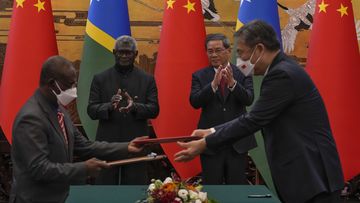 Visiting Solomon Islands Prime Minister Manasseh Sogavare, center left, and Chinese Premier Li Qiang, center right, applaud as both countries&#x27; officials exchange signed documents at the Great Hall of the People in Beijing, Monday, July 10, 2023.