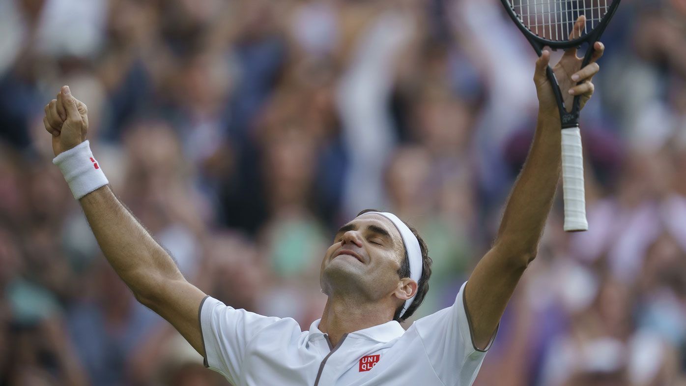 Roger Federer celebrates match point during his match against Rafael Nadal on day 11 at the All England Lawn and Croquet Club. 