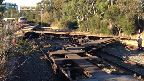 Freight train collision derails carriages and forces road closures in Adelaide