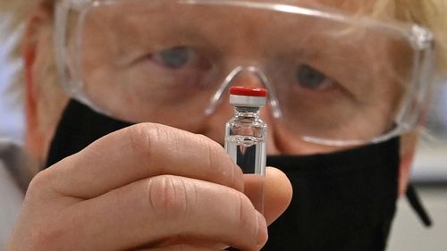 UK Prime Minister Boris Johnson with a vial of the AstraZeneca / Oxford University COVID-19 candidate vaccine, known as AZD1222.