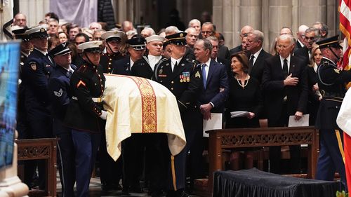 Former Presidents front row from left, George W. Bush with Laura Bush and Joe Biden with Jill Biden, look on as a joint services body bearer team arrive with the casket of former Vice President Dick Cheney at the Washington National Cathedral.
