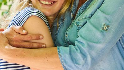 Mother hugging teenage daughter