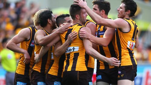 Matt Suckling of the Hawks is congratulated by team mates after kicking a goal. (AAP)